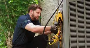 Service technician troubleshooting residential HVAC wiring