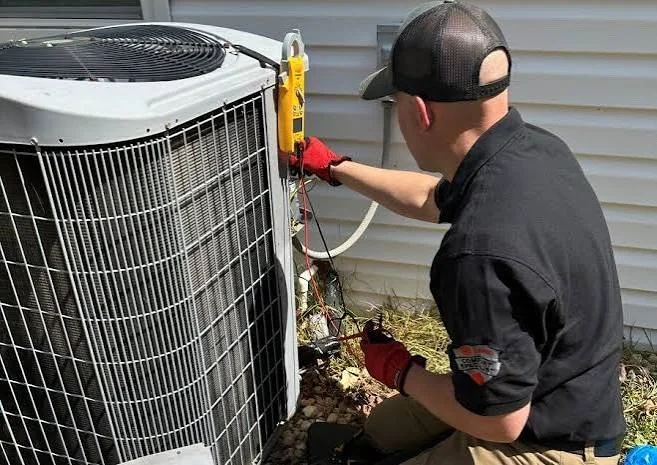 Heating and cooling technician inspecting an outdoor system