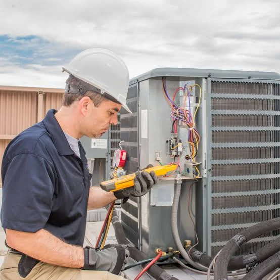 Technician performing preventive maintenance on HVAC controls