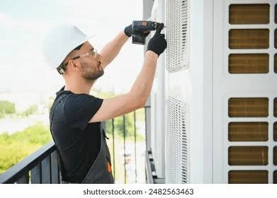 HVAC technician inspecting a wall-mounted residential cooling unit